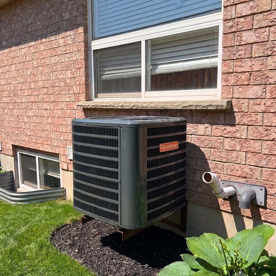 Goodman central AC condenser unit installation on AC mount in Waterloo.