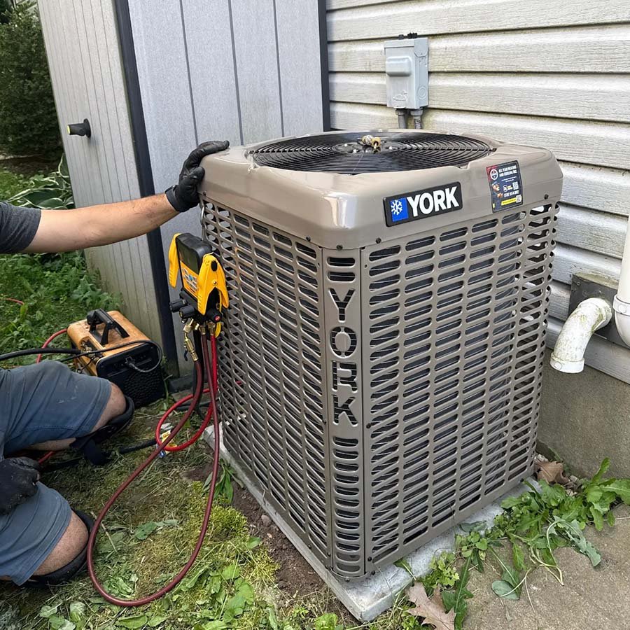 Newly installed residential York central air conditioner next to a Waterloo home.