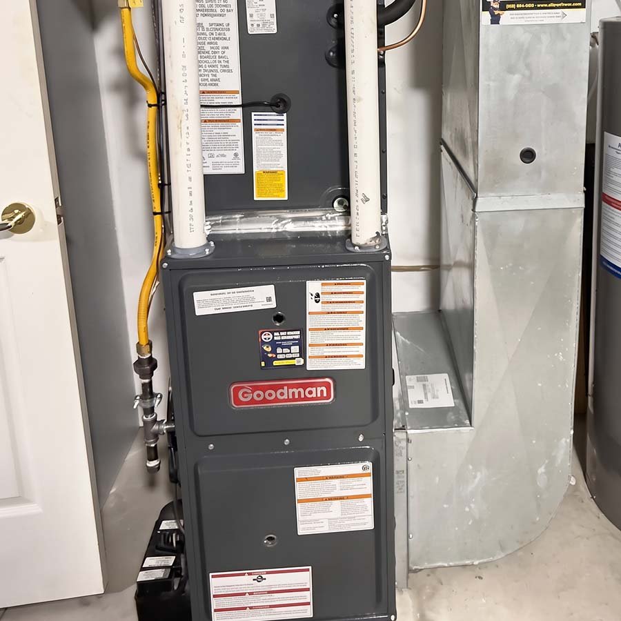 A newly installed high-efficiency Goodman gas furnace in a residential basement utility room in Cambridge.