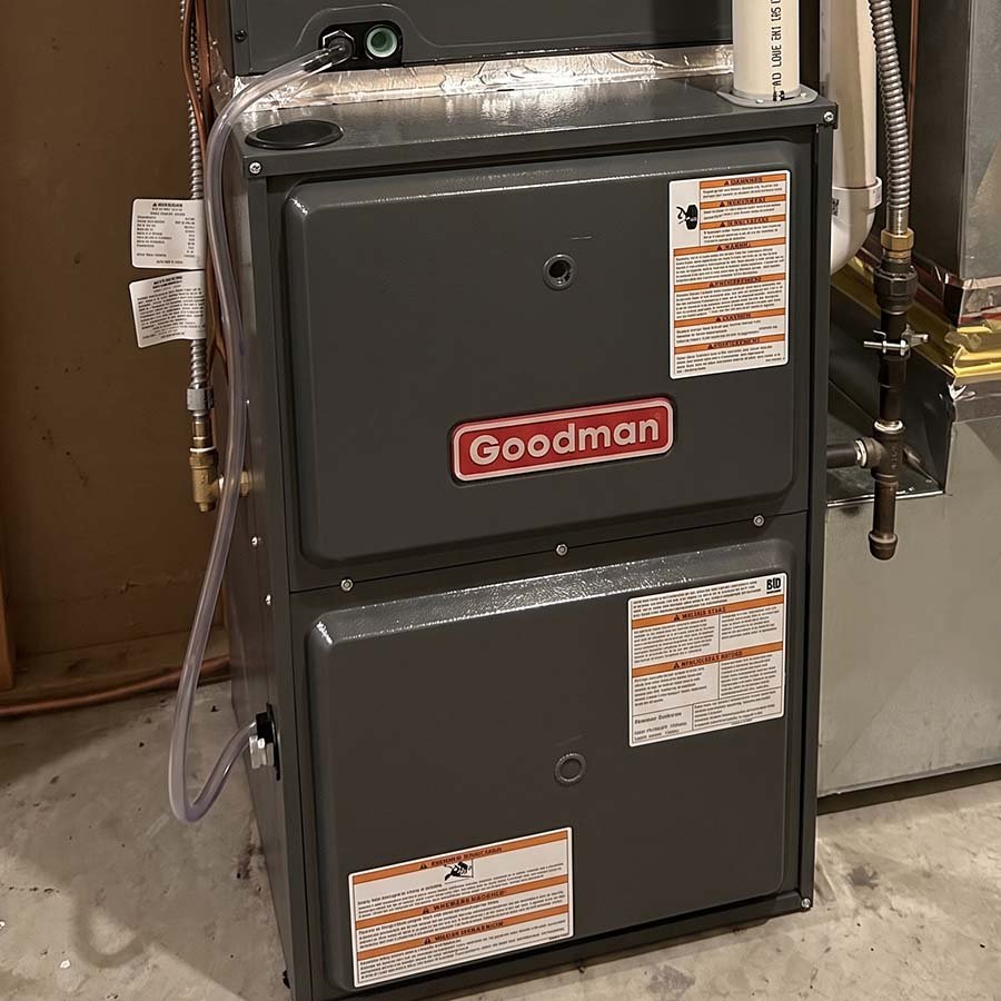 Front view of a Goodman furnace unit expertly fitted to new sheet metal ductwork during a residential upgrade in Kitchener.