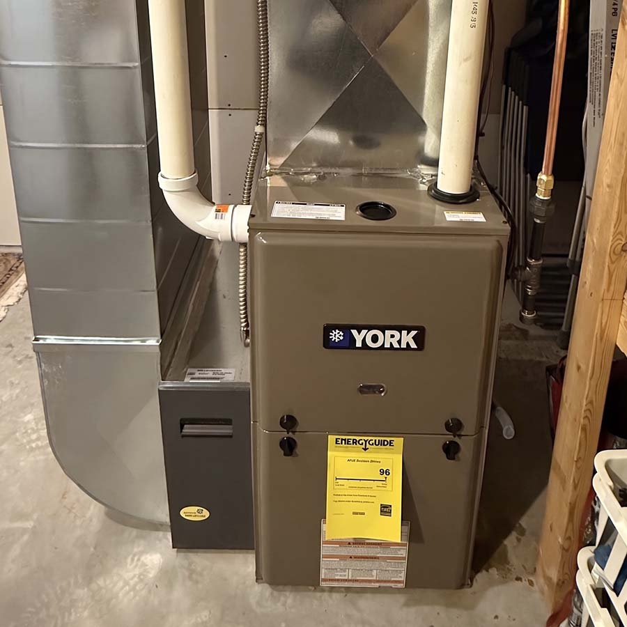 A newly installed high-efficiency York furnace replacing an older model in a Guelph home's utility space.